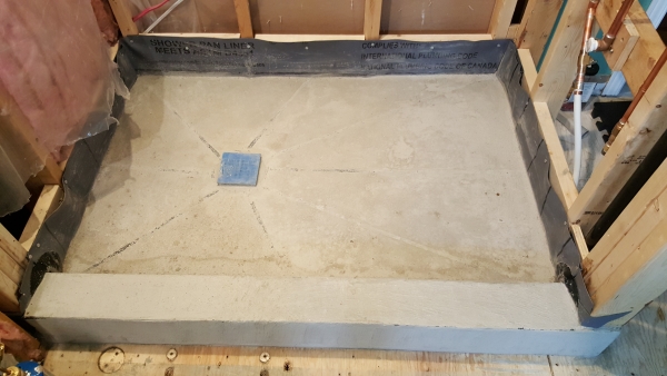 Shower mud floor with drain and drain cover installed